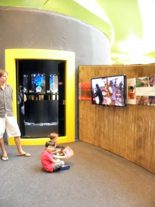 Photo of children watching a film at the Ancient Treasure Ships exhibit